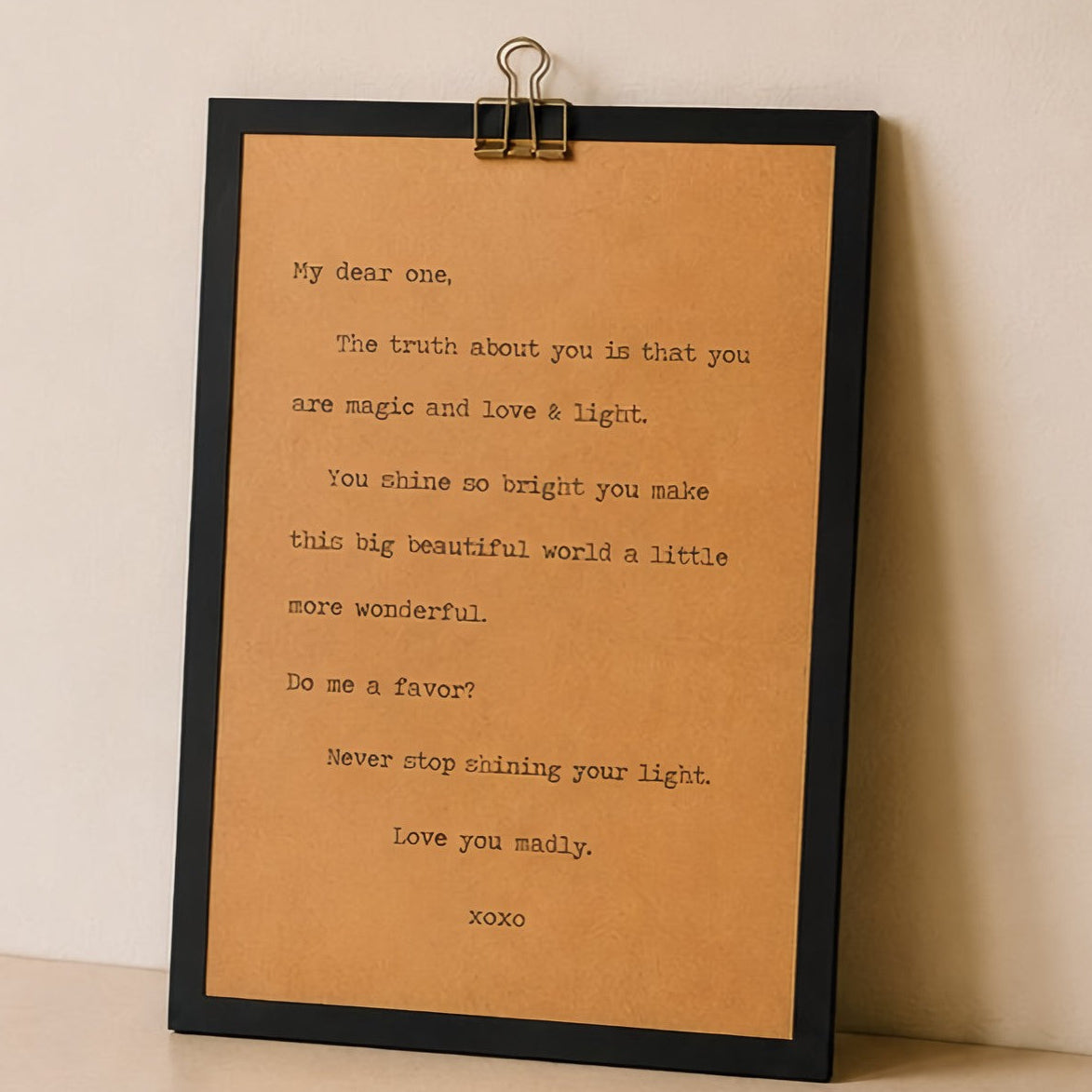 9x12 encouragement wood sign with kraft paper quote about shining your light displayed against a neutral wall