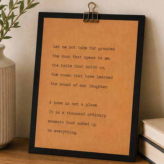 9x12 housewarming wood sign with kraft paper quote design displayed on a wooden table beside a neutral vase and books