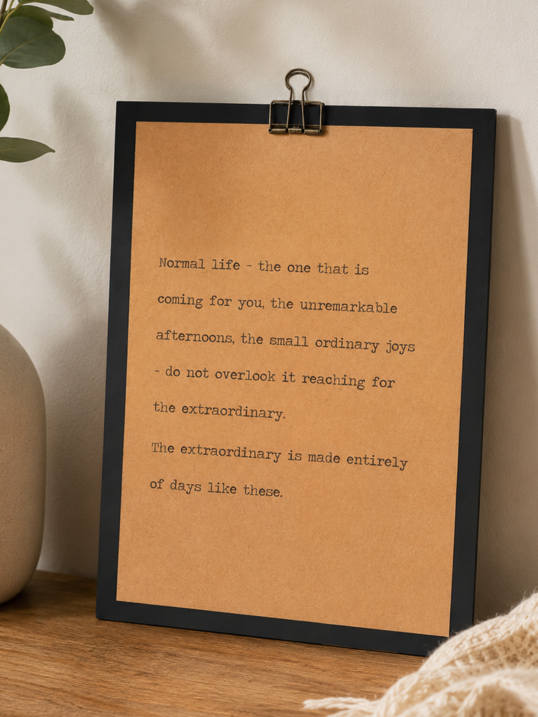 9x12 new beginnings wood sign with kraft paper quote design styled on a wooden tabletop with neutral vase and greenery