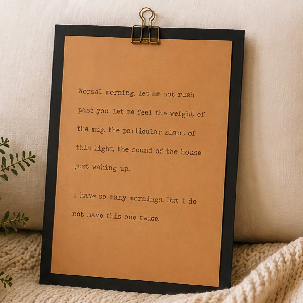 Meaningful morning quote wood sign with black border and kraft paper design styled with greenery and a knit blanket