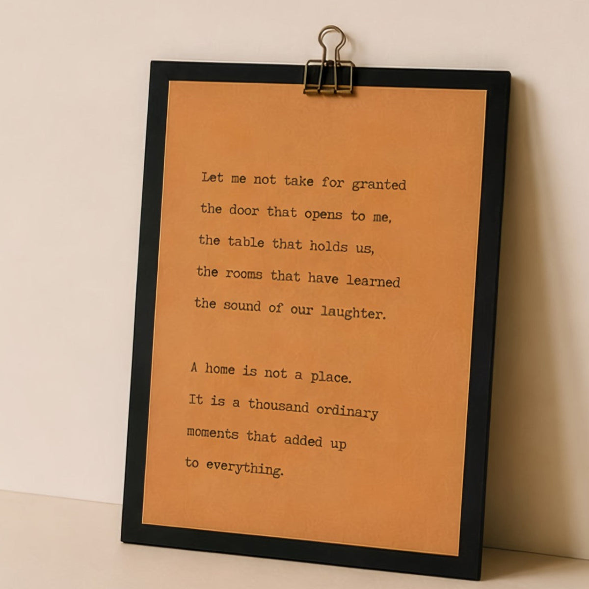 Neutral housewarming wood sign with meaningful quote displayed against a warm beige wall