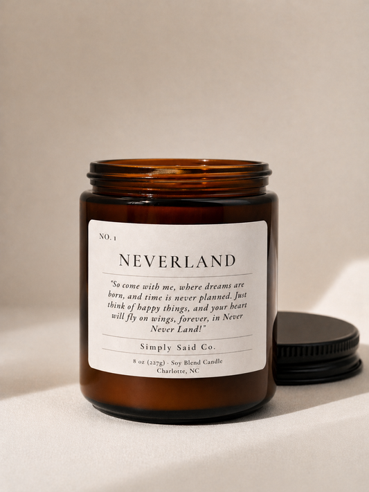 neverland candle in amber jar with wood wick and Peter Pan Quote
