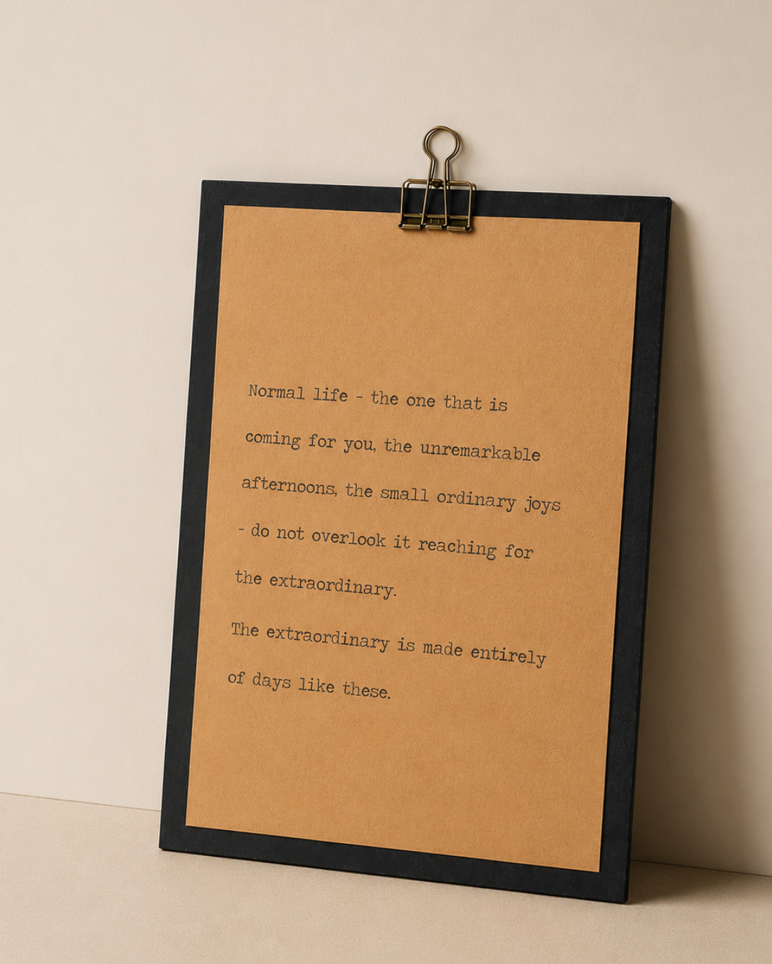 New beginnings quote wood sign with black border and kraft paper design styled against a warm neutral wall
