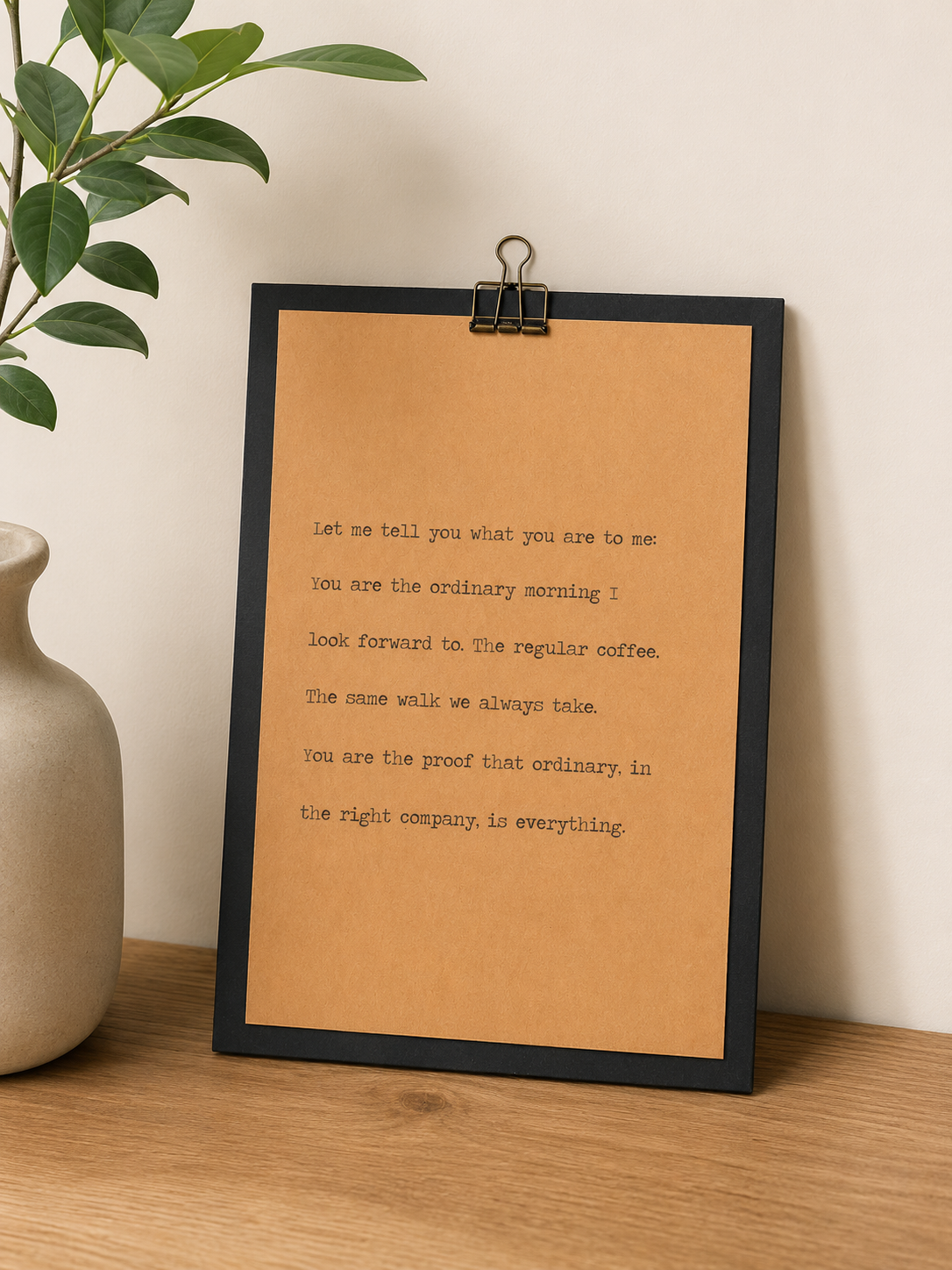 Minimal 9x12 wood quote sign with kraft paper design displayed with a green plant and stone vase.