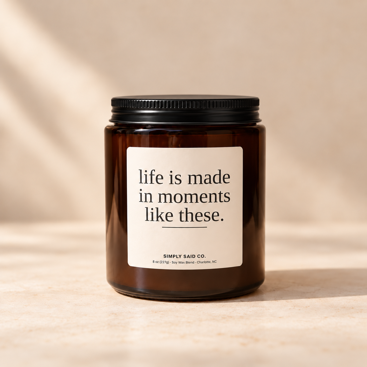 Life Is Made in Moments apple and sandalwood soy candle in amber glass jar with black lid