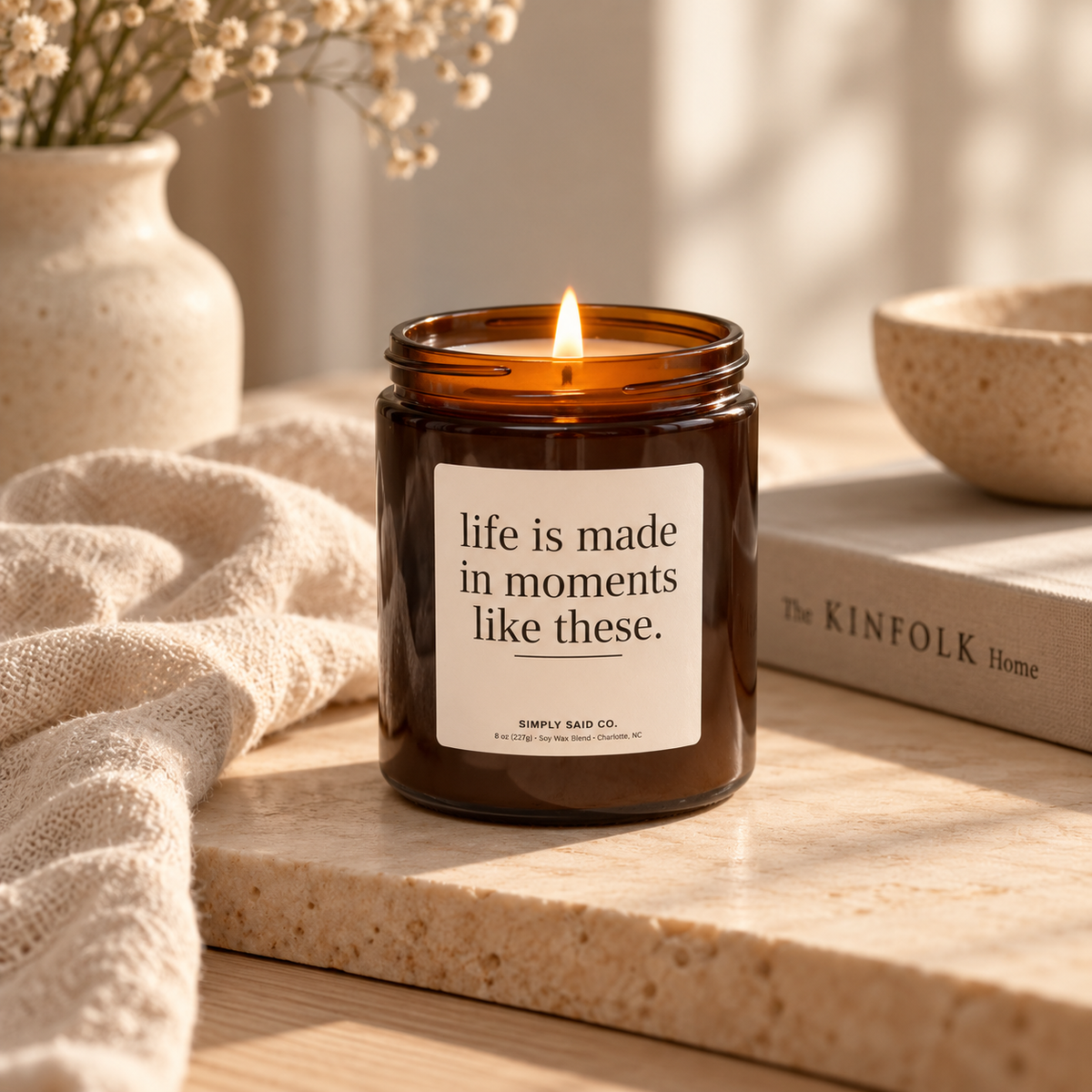Life Is Made in Moments quote candle styled in a warm neutral home
